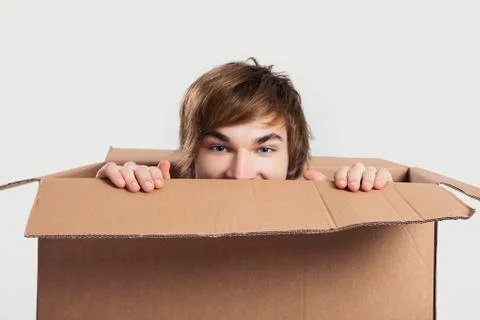 Man inside a card box Stock Photos