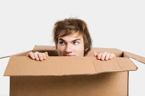 Man inside a card box Stock Photos
