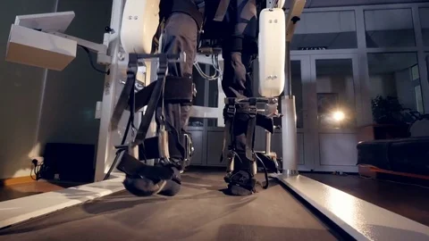 A man inside an exoskeleton walking a treadmill. Stock Footage 77275368