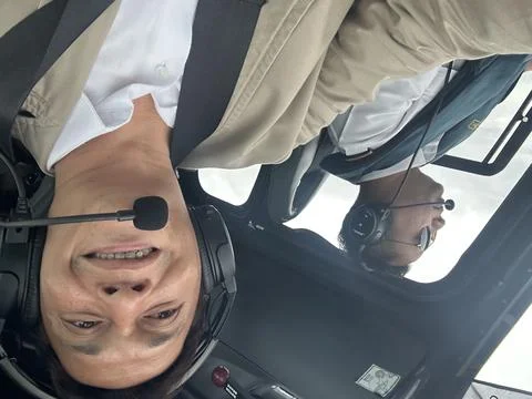 Man inside a flying Helicopter Stock Photos
