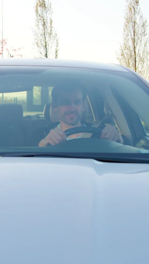 Man inspecting car condition while sitting inside vehicle, showcasing interior Stock Footage 318475735