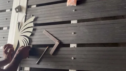 Man inspecting design before affixing it onto gate. Stock Footage 312322413
