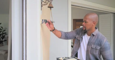 Man inspecting faded patch at doorway by bell, painting for touch-up with brush, Stock Footage 335928382