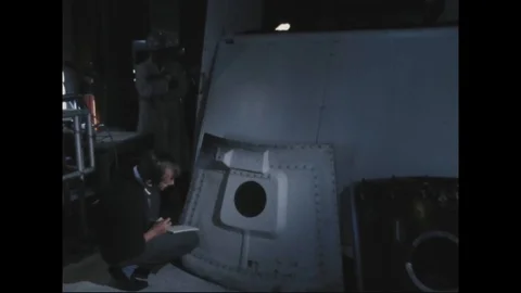 Man inspecting outer hatch and noting on notepad - 1967 Stock Footage 104330695