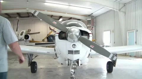 Man Inspecting Prop Plane Stock Footage 12597663