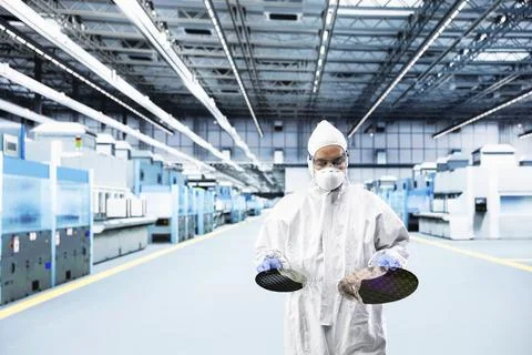Man inspecting semiconductor production infrastructure Stock Photos