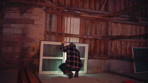 A Man is Inspecting the Window to be Installed on the Barn - Static Shot Stock Footage 300963900