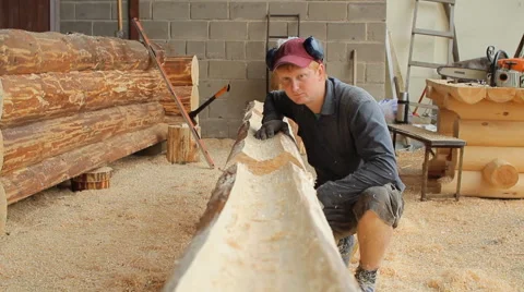 A man inspects beam for future home. Construction works with a wooden structure Stock Footage 65414520