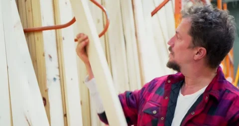 Man Inspects Lumber at Hardware Store 스톡 동영상 323779002