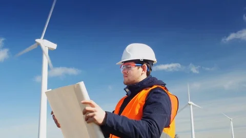 A man inspects the windmills is referring to the plan Stock Footage 72114870