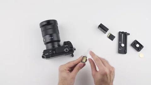Man install SD card into Sony photo video camera with his hand Stock Footage 138066285