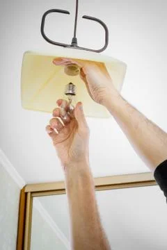 Man Installing a Bulb Фото