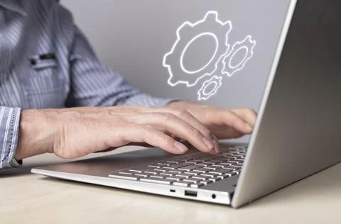 Man installing, configuring system settings at laptop. Computer repair 스톡 사진