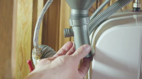 Man installing a drain for a kitchen sink 스톡 동영상 128928755