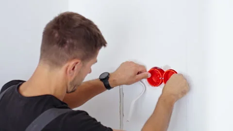 Man installing electrical boxes in wall 库存影片 345453131