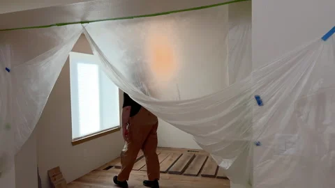 Man installing floor planks near curtained window Stock Footage 327855167