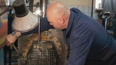 Man installing gear box of kamaz on a boring machine Stock Footage 81544467
