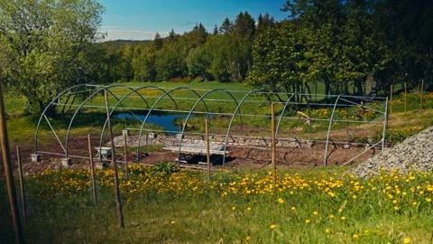 Man Installing Greenhouse Framework In Backyard Vídeo Stock 342573545