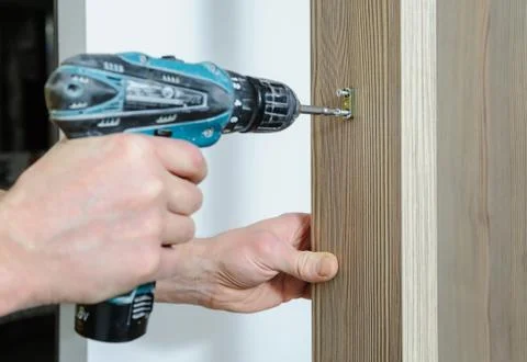 A man is installing a hook. Stock Photos