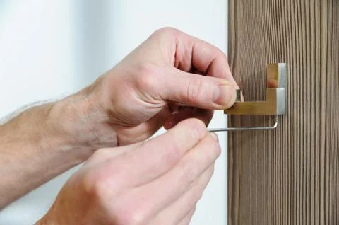 A man is installing a hook. Stock Photos