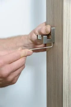 A man is installing a hook. Stock Photos