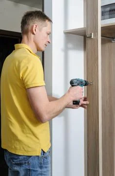 The man is installing a hook. Stock Photos