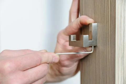 A man is installing a hook. Stock Photos