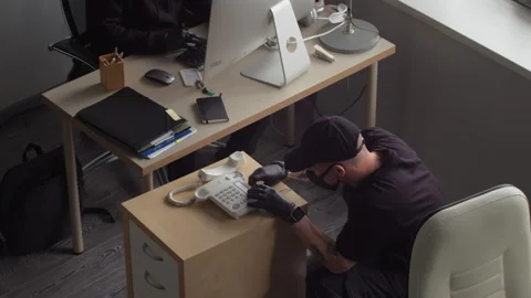 Man Installing Listening Bug into Phone Spying on Corporate Data in Office Stock Footage 313546891