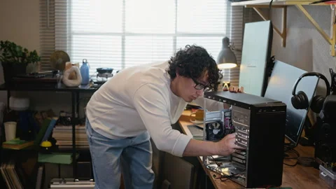 Man Installing Motherboard Inside Desktop Computer Case Stock Footage 338424988