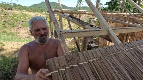 Man installing a native roof Stock Footage 277673160
