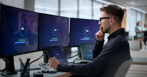 Man Installing New Software Update On Laptop To Fix Slow Loading. Stock Photos
