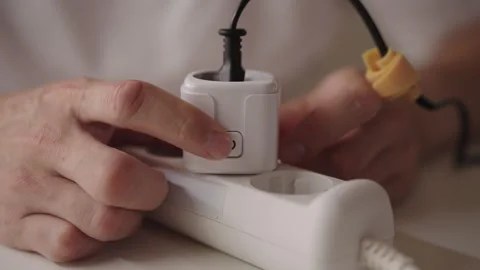Man installing smart socket on extension cord, upgrading home automation and Stock Footage 318307695