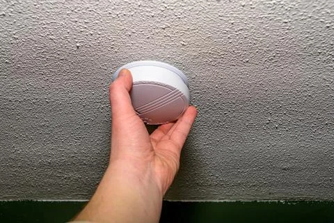 Man installing smoke detector Stock Photos