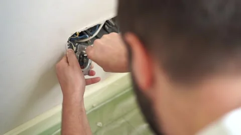 Man installing socket. electrician hands holding screwdriver. Renovation, repair Stock Footage 247706463