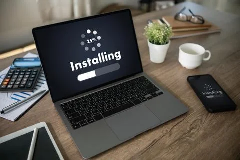 Man installing Software Update On Mobile Phone And Laptop digital technolog.. 写真素材