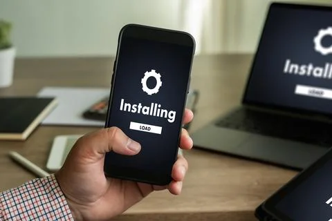 Man installing Software Update On Mobile Phone And Laptop digital technolog.. 스톡 사진