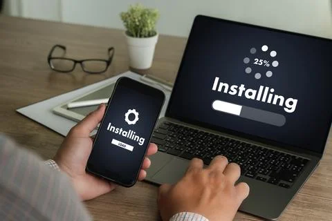 Man installing Software Update On Mobile Phone And Laptop digital technolog.. Foto stock