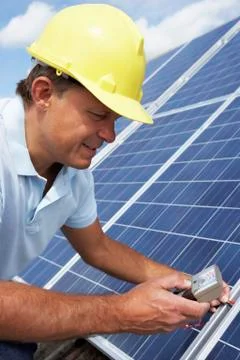 Man installing solar panels Stock Photos