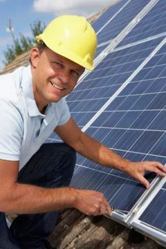 Man installing solar panels Stock Photos