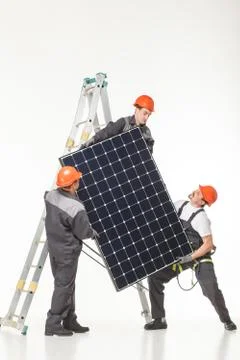 Man installing solar panels Stock Photos