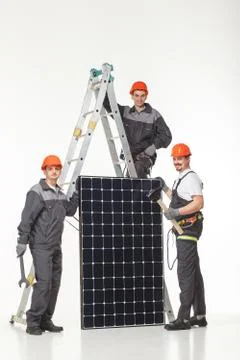 Man installing solar panels Stock Photos