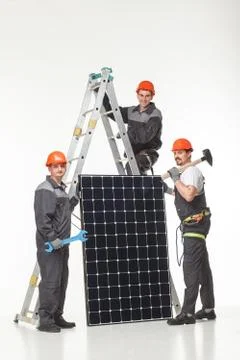 Man installing solar panels Stock Photos