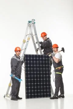 Man installing solar panels Stock Photos