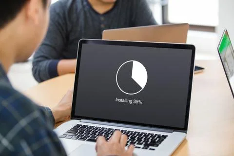 Man Installing update with circle load percentage waiting indicator concept on Stock Photos