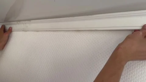 Man installing white ceiling molding at home interior. Renovation work, Stock Footage 337355022