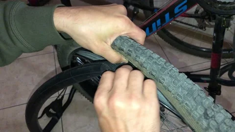 A man installs a Bicycle wheel camera Stock Footage 142697628