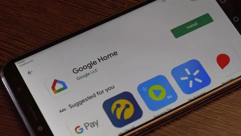 A man installs a Google Home application on his android smartphone. Stock Footage 134447276