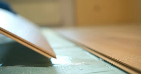 A man installs a laminate board on a polystyrene substrate detailed view Stock Footage 128260951