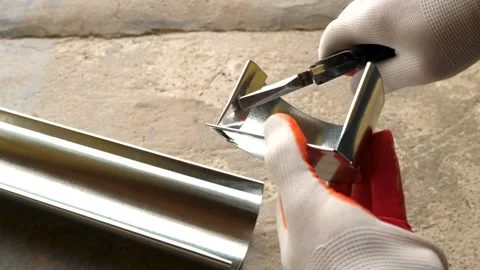 A man installs a metal gutter system. Water drainage system of the house. Video stock 286213990