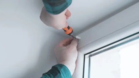 Man installs roller blinds. Handyman mesures window to fix it. Video stock 305342880